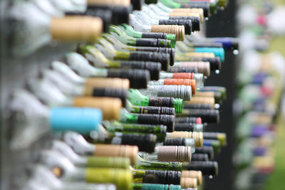 Wet wine bottles in rack during rain