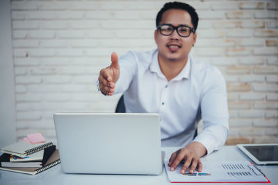 Mid adult man using laptop on table