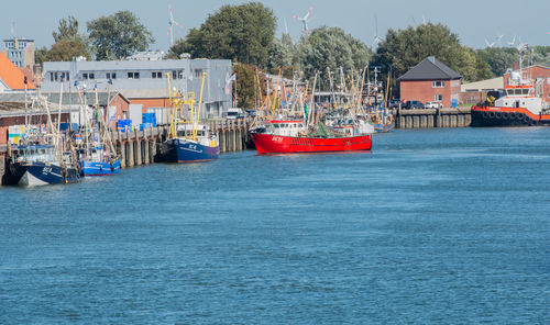 Boats moored in sea against clear sky