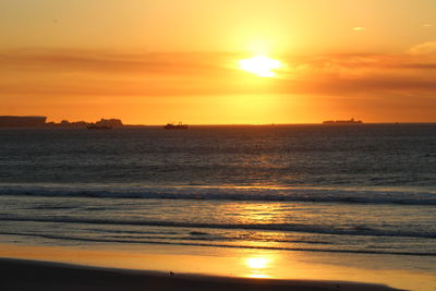 Scenic view of beach against sky during sunset