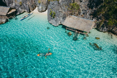 Drone view of man kayaking in sea on sunny day