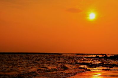 Scenic view of sea against orange sky