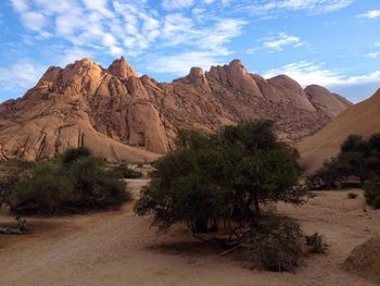 Scenic view of mountains against cloudy sky