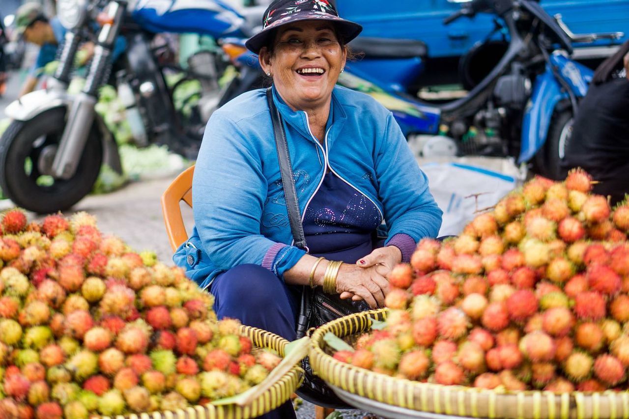 Portrait of woman holding fruits in market