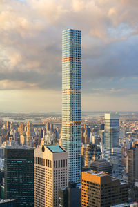 View of skyscrapers against cloudy sky