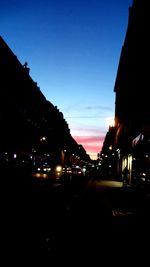 Cars on road against sky at night