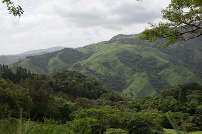 Scenic view of mountains against cloudy sky