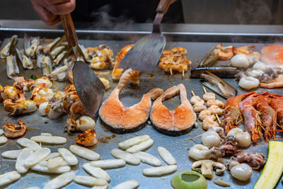 Close-up of person preparing food in market