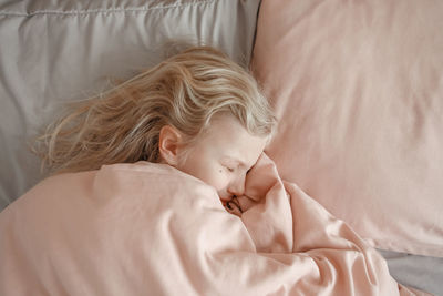 Cute baby sleeping on bed at home