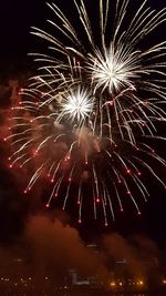 Low angle view of firework display at night