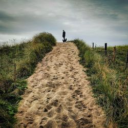 Woman standing on footpath