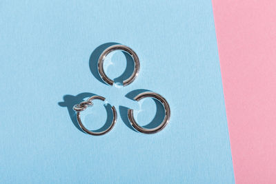 Close-up of wedding rings on blue background