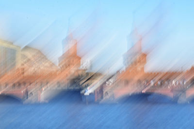 Blurred motion of buildings against blue sky