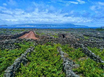 Scenic view of land and sea against sky