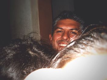 Close-up portrait of smiling young woman with horse