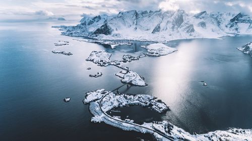 Aerial view of frozen sea and snowcapped mountains during winter