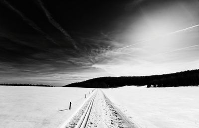 Panoramic view of railroad tracks against sky during winter