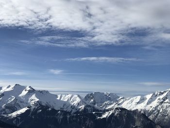 Scenic view of snowcapped mountains against sky