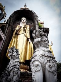 Low angle view of statue against building