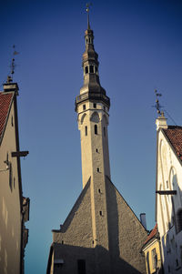 Low angle view of tower against blue sky