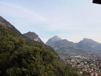 Scenic view of townscape and mountains against sky