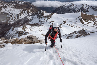 Person with umbrella on snowcapped mountain