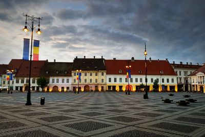 Buildings in city against sky at dusk
