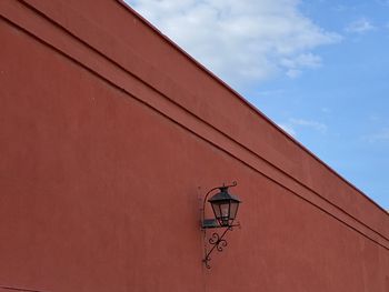 Low angle view of street light against building