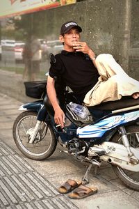 Man sitting on street