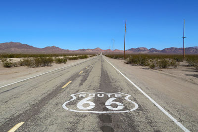 Road sign against clear sky