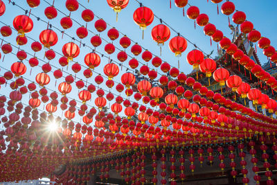 Low angle view of lanterns hanging against sky