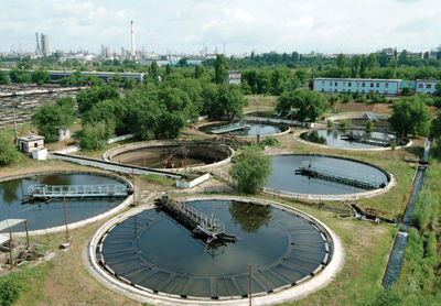 High angle view of built structure by trees against sky