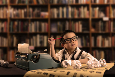 Portrait of a boy sitting on book