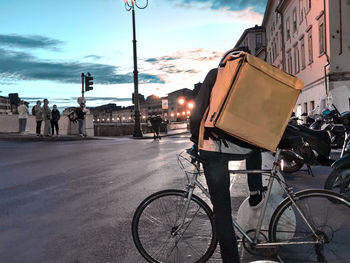 Rear view of people riding bicycles on street