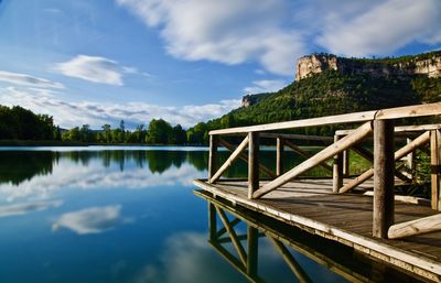 Pier over lake against sky