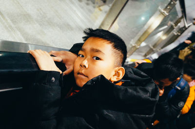 Portrait of cute boy sitting in bus