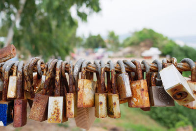 Close-up of abandoned padlocks on railing