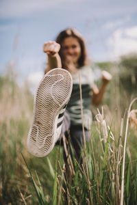 Young woman standing on field