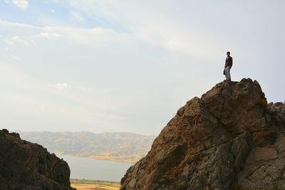 Rear view of man standing on mountain