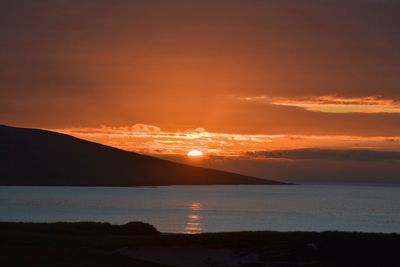 Scenic view of sea against romantic sky at sunset