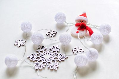 Close-up of christmas ornaments on white background