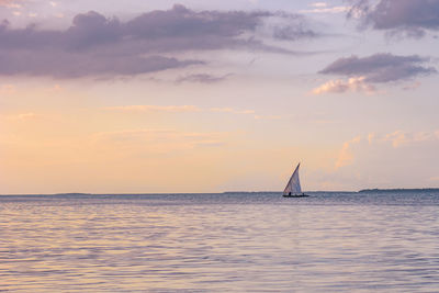 Scenic view of a fishing boat at the ocean during sunset