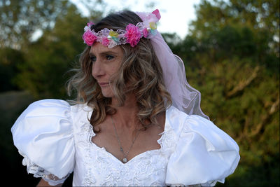 Portrait of woman with pink flower