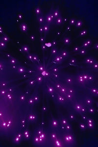 Low angle view of illuminated sky at night