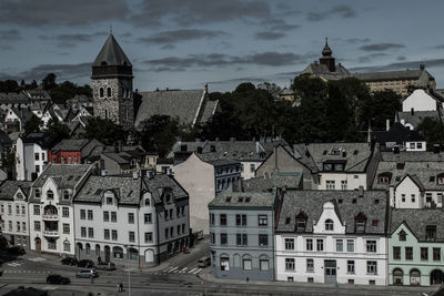 High angle view of buildings in town against sky, alesund.