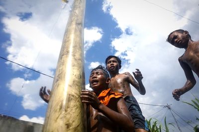 Low angle view of people against sky