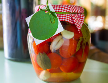 Close-up of fruits in glass jar on table