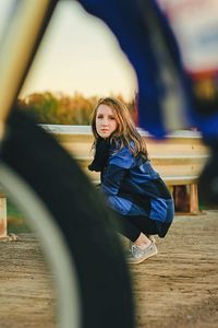 Portrait of smiling young woman against sky