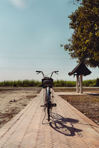 Bicycle on field against clear sky