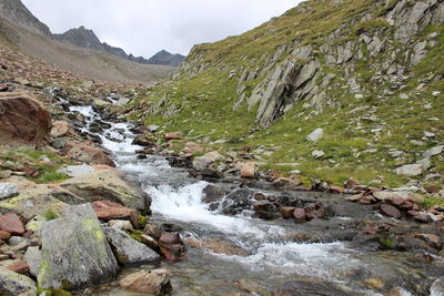 Scenic view of waterfall against sky